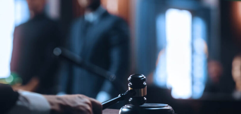 A judge's gavel striking a sound block, symbolizing a final court ruling from the Abu Dhabi Court of Cassation on business owner liability.