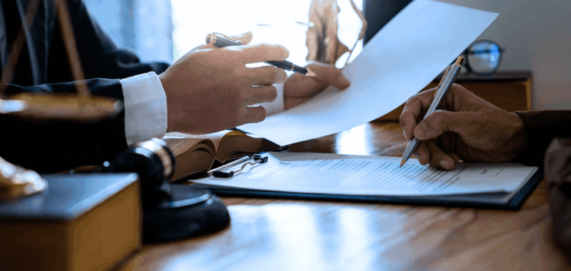 Legal professional reviewing tax assessment documents and preparing challenge documentation in law office