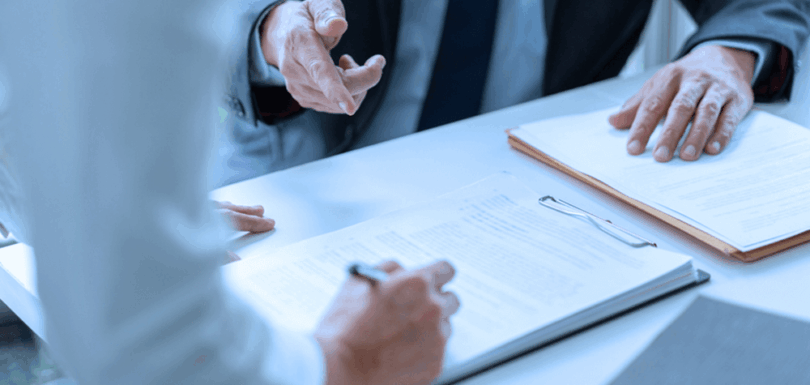 Legal professionals reviewing real estate register law documents and Article 11 provisions during consultation