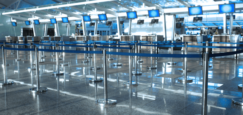 Empty airport check-in area in the UAE, symbolizing travel bans on personal guarantors