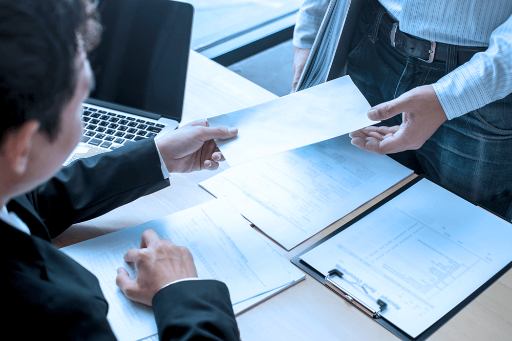 Formal notice being handed over to an LLC manager during a business meeting