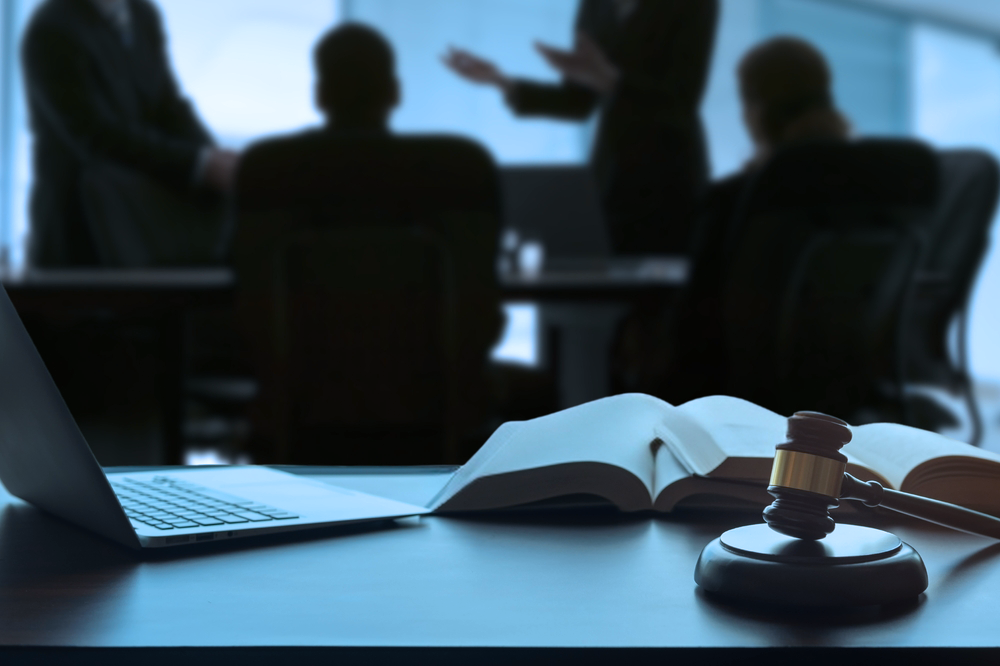 Law conference with gavel, book, and laptop representing UAE legal professionals shaping judicial principles